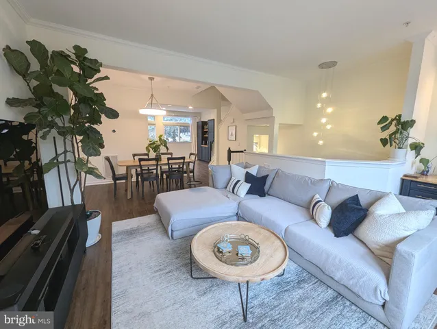 a living room with furniture a rug and a chandelier