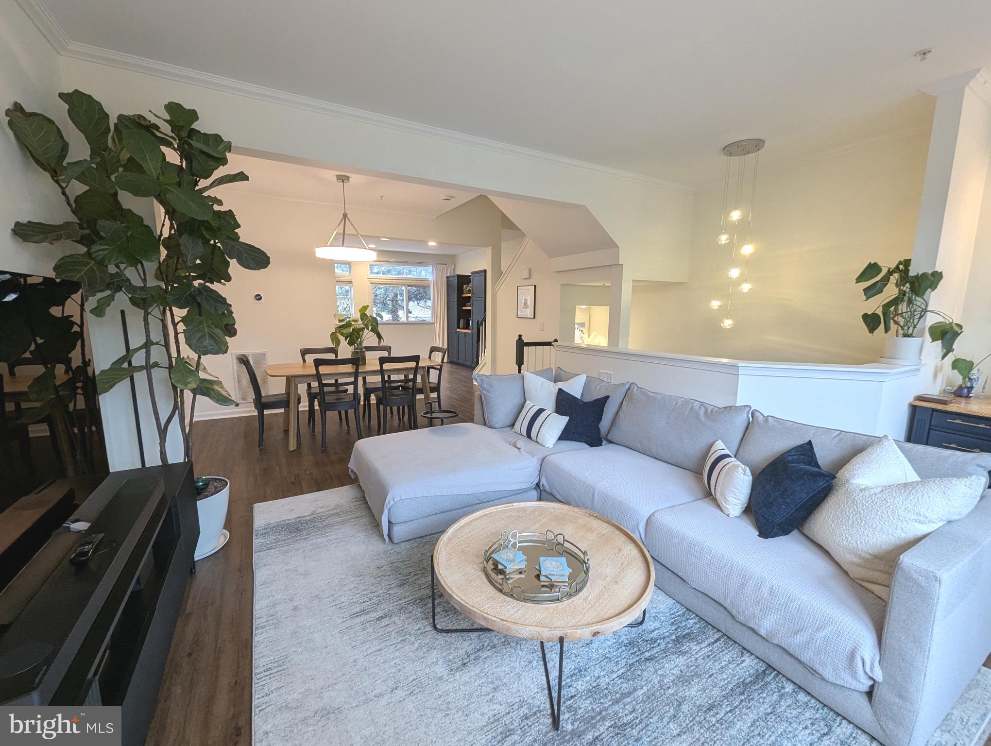 a living room with furniture a rug and a chandelier