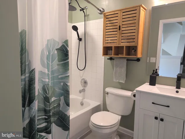 a bathroom with a toilet sink and shower