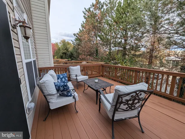 a roof deck with couches and wooden floor