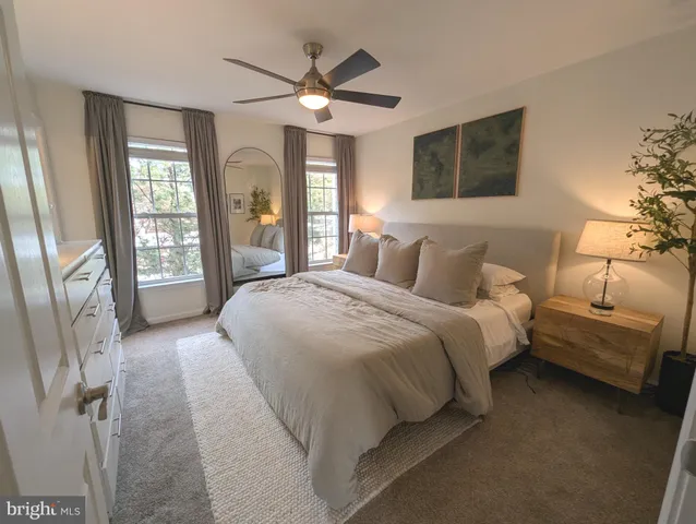 a spacious bedroom with a large bed and a chandelier