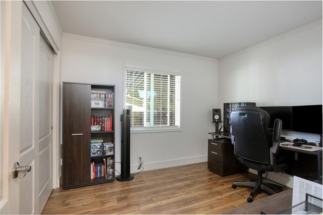 a view of a workspace with furniture and a window