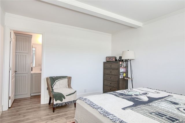 a bedroom with a bed and a chair