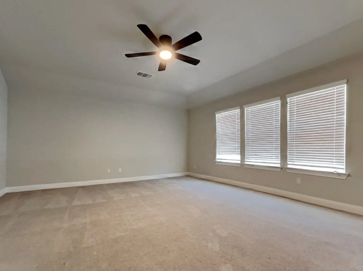 3610 Thunian Pass Pflugerville, TX 78660 - Photo 13 of 27 an empty room with chandelier fan and windows