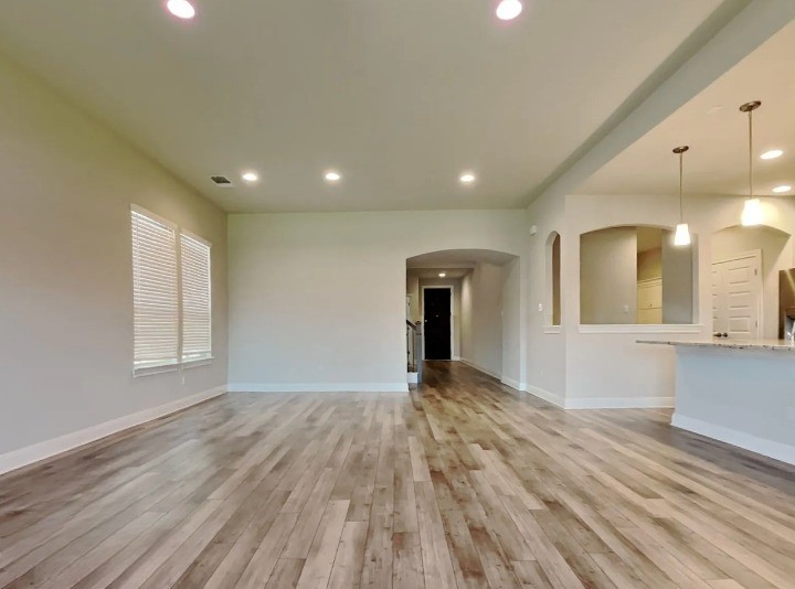 3610 Thunian Pass Pflugerville, TX 78660 - Photo 20 of 27 a view of an empty room with wooden floor and a window
