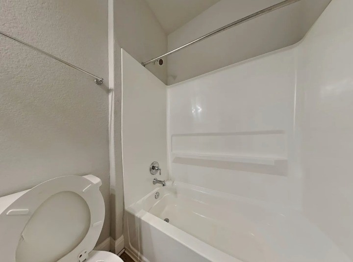 3610 Thunian Pass Pflugerville, TX 78660 - Photo 24 of 27 a bathroom with a toilet and a bathtub
