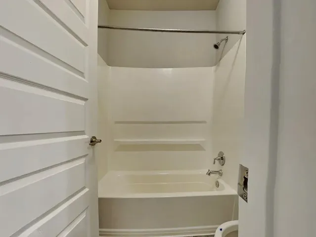 a bathroom with a shower and a bath tub