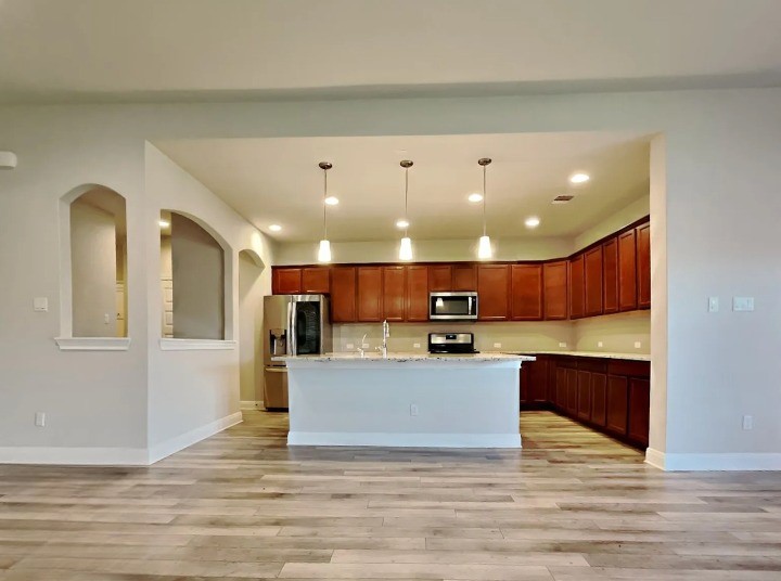 3610 Thunian Pass Pflugerville, TX 78660 - Photo 27 of 27 a view of kitchen with kitchen island microwave and cabinets