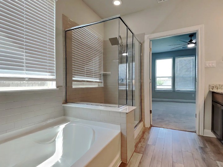 3610 Thunian Pass Pflugerville, TX 78660 - Photo 9 of 27 a bathroom with a bathtub and a shower