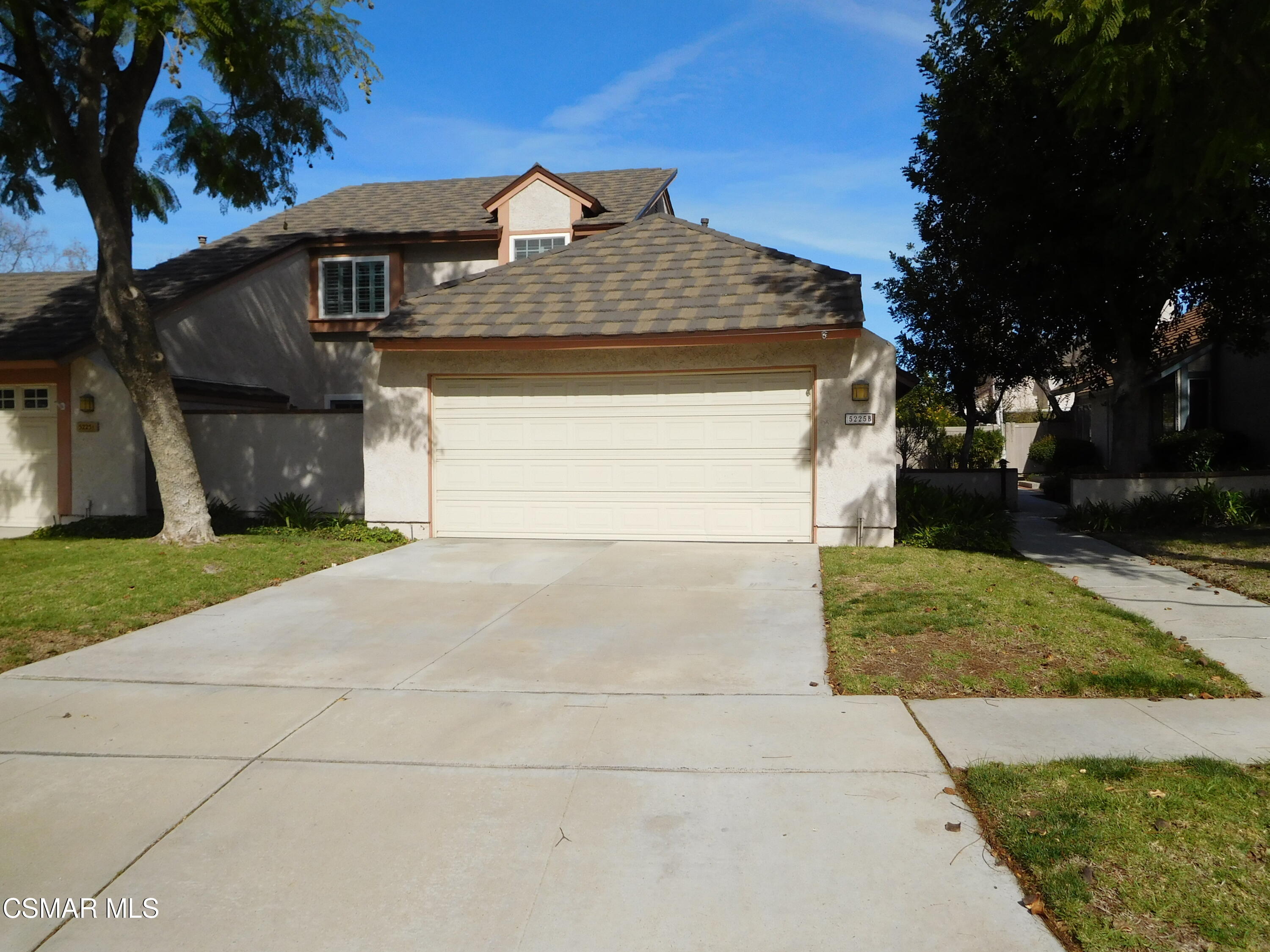 5225 Diane Street, Unit B Simi Valley, CA 93063 - Photo 1 of 24 a front view of a house with a yard and garage
