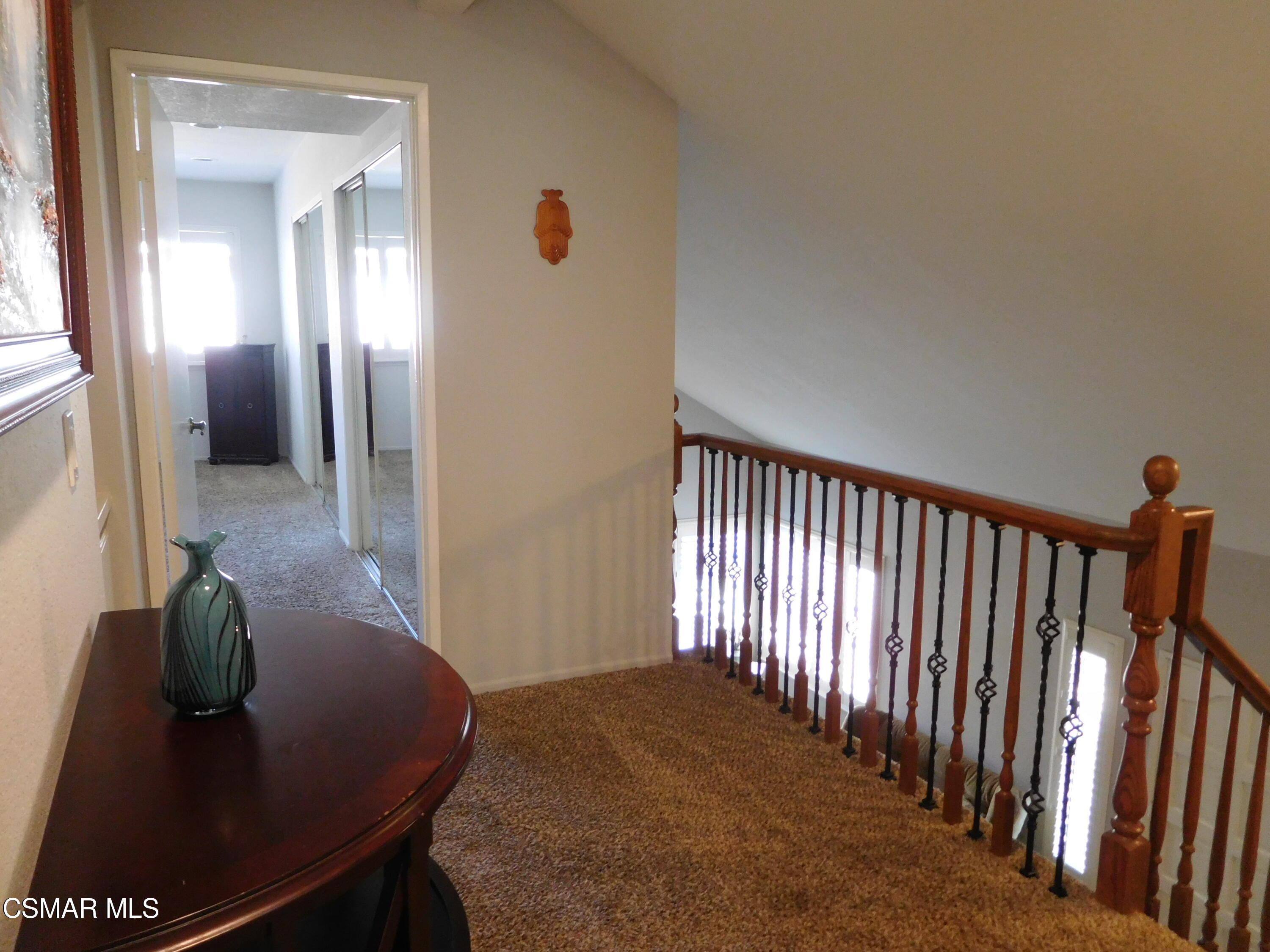 5225 Diane Street, Unit B Simi Valley, CA 93063 - Photo 13 of 24 a view of a hallway with a dining room and stairs