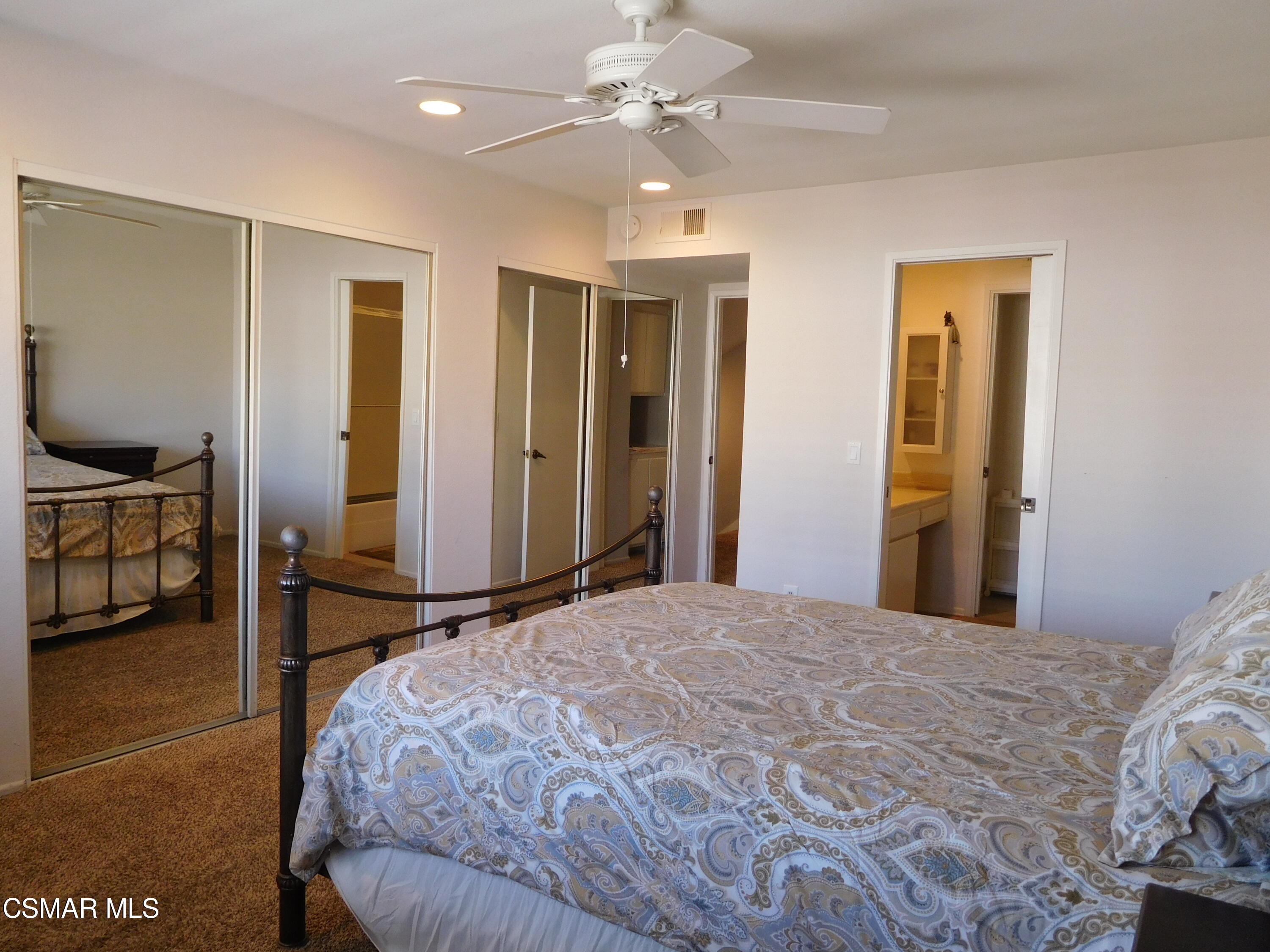 5225 Diane Street, Unit B Simi Valley, CA 93063 - Photo 15 of 24 a bedroom with a bed and a chandelier