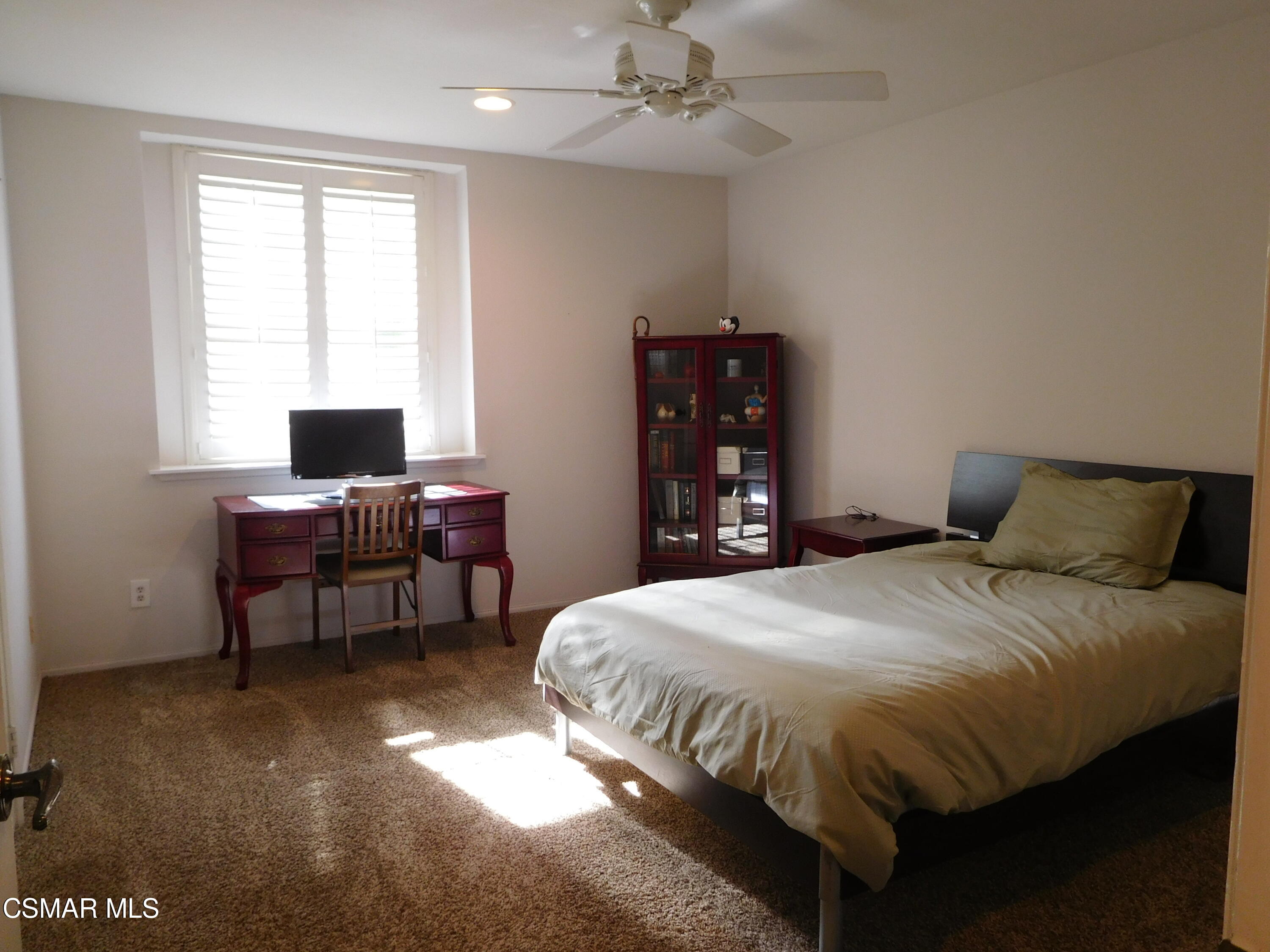 5225 Diane Street, Unit B Simi Valley, CA 93063 - Photo 19 of 24 a bedroom with a bed table and chair