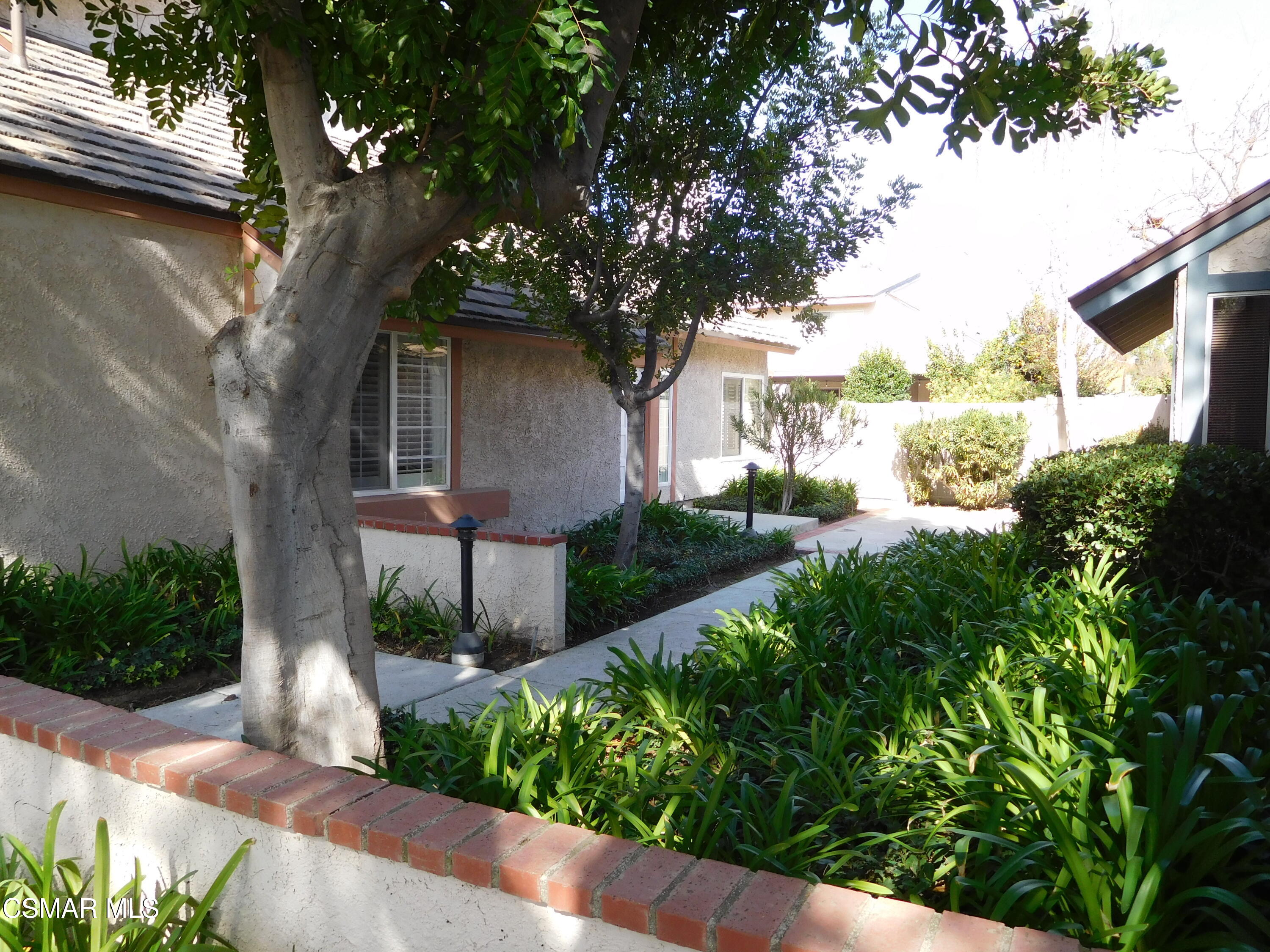 5225 Diane Street, Unit B Simi Valley, CA 93063 - Photo 3 of 24 a front view of a house with garden