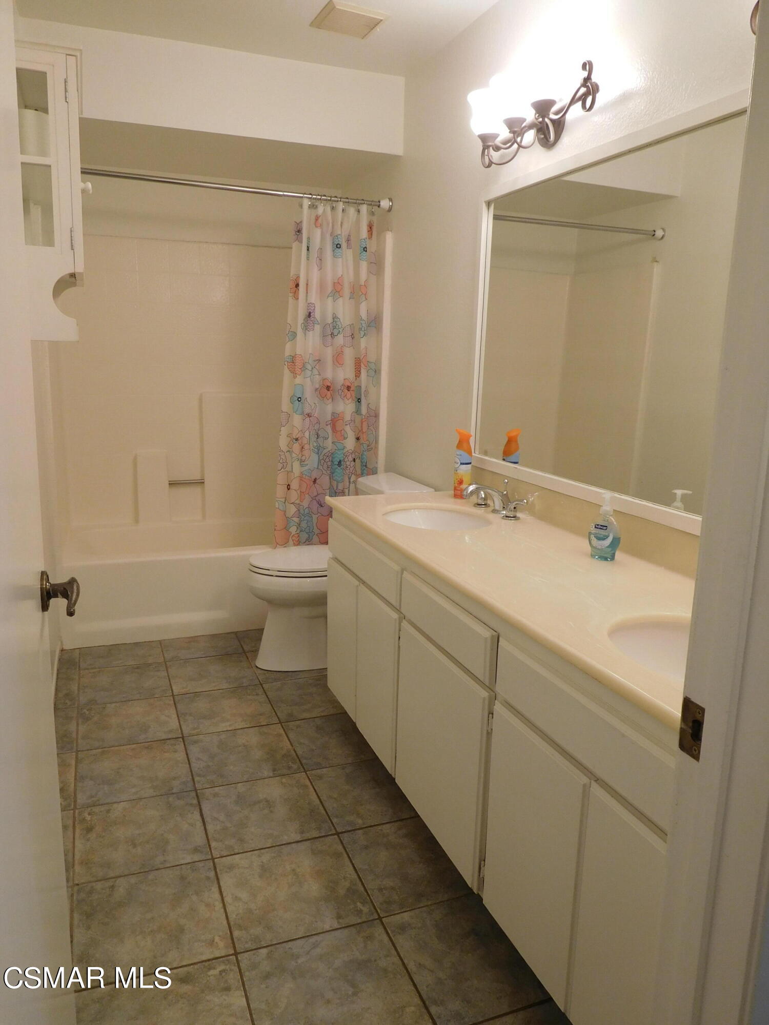 5225 Diane Street, Unit B Simi Valley, CA 93063 - Photo 10 of 24 a bathroom with a sink a toilet and mirror