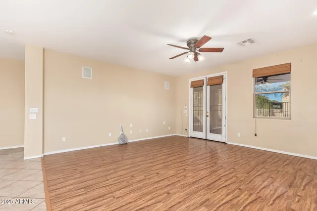 a view of a kitchen with granite countertop a sink and dishwasher a stove top oven with wooden floor