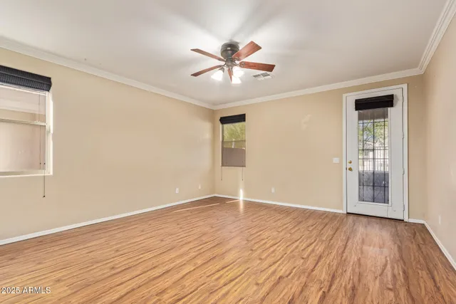 a view of a room with a window and a ceiling fan