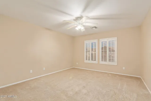a view of empty room with ceiling fan
