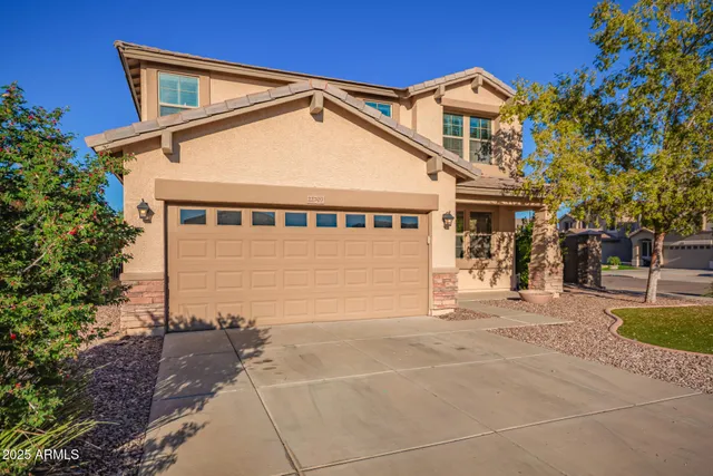 a front view of a house with a yard and garage
