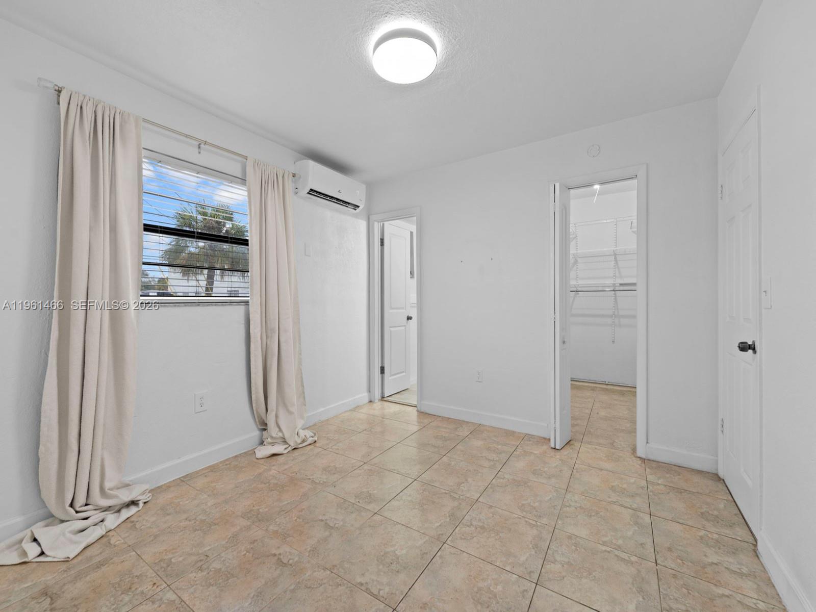4444 Southwest 67th Avenue, Unit 7 Miami, FL 33155 - Photo 12 of 28 an empty room with windows and wardrobe