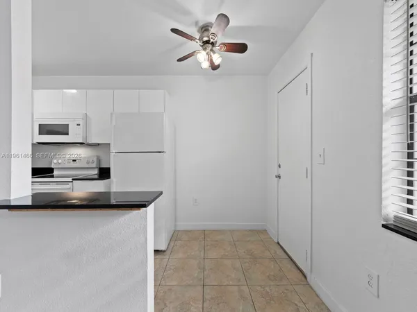 a kitchen with kitchen island a stove a sink and a refrigerator with wooden floors