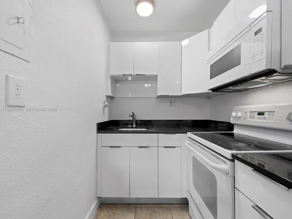 a kitchen with stainless steel appliances granite countertop a sink and a stove