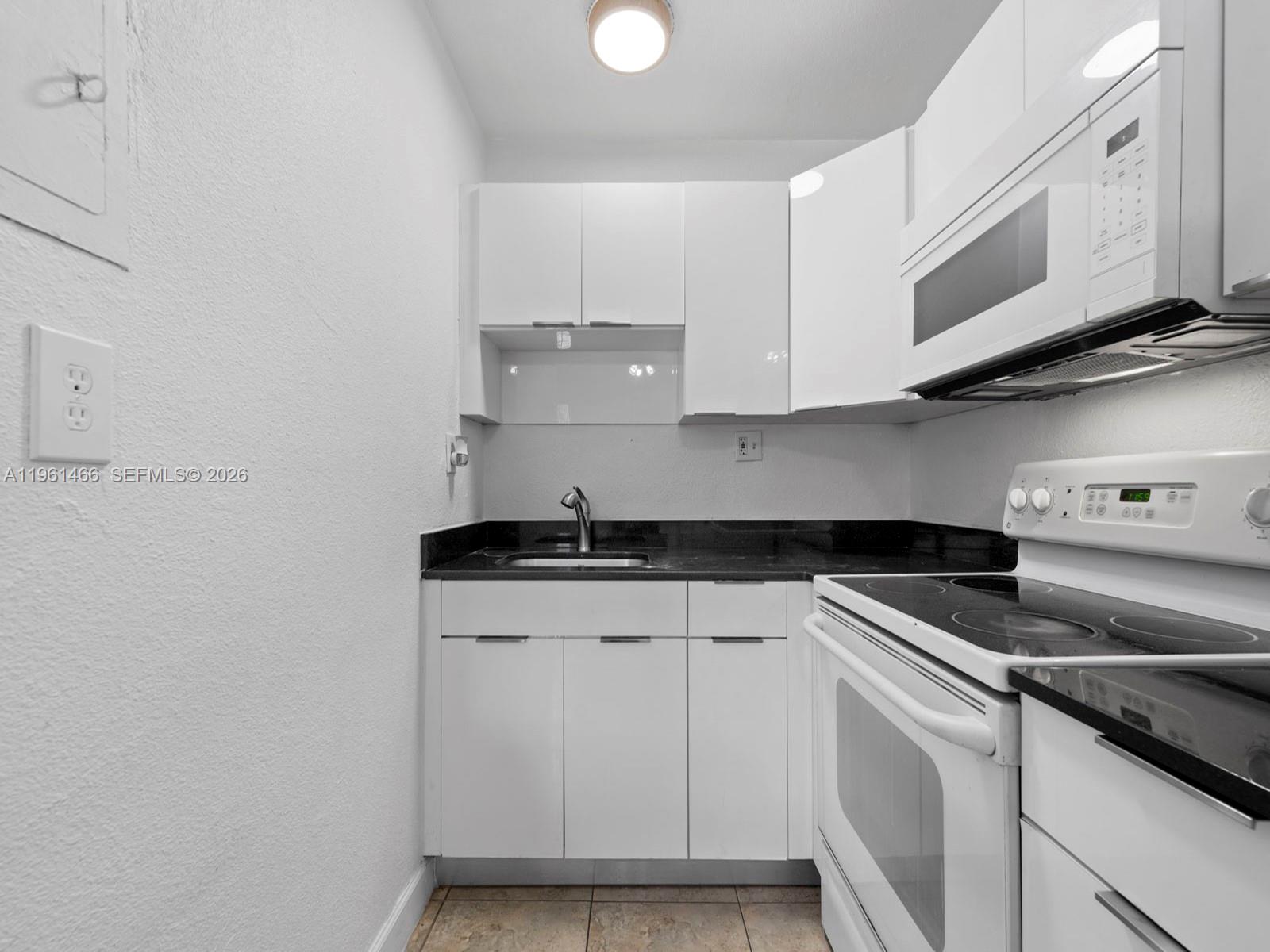 4444 Southwest 67th Avenue, Unit 7 Miami, FL 33155 - Photo 8 of 28 a kitchen with stainless steel appliances granite countertop a sink and a stove