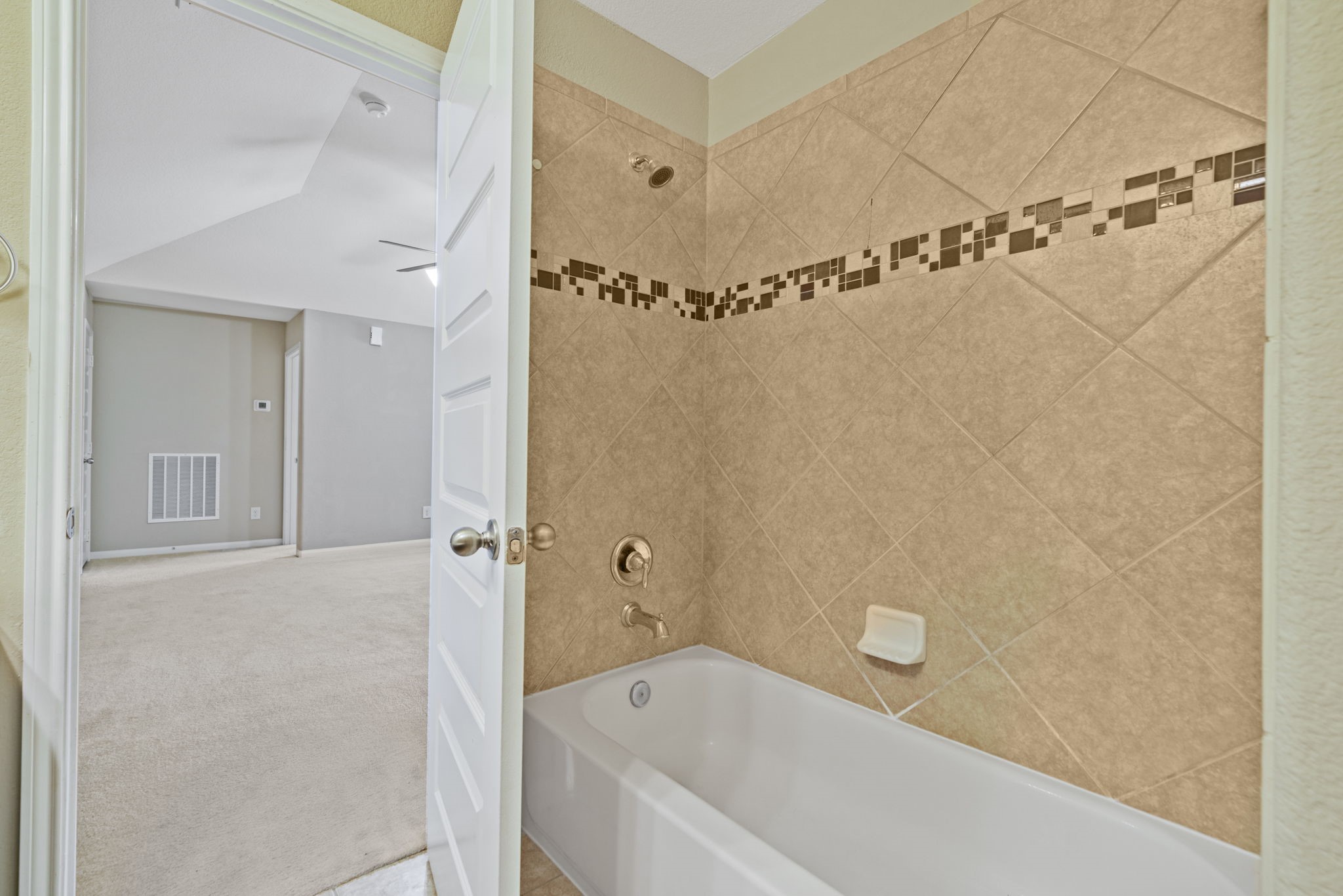 22523 Birch Ridge Meadow Drive Spring, TX 77389 - Photo 32 of 39 a bathroom with a bathtub and a shower