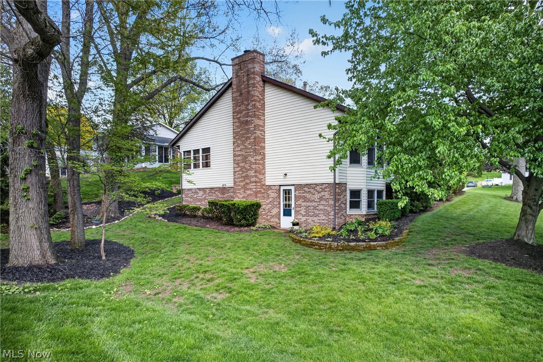5346 Burlawn Street Northwest Canton, OH 44708 - Photo 34 of 40 Sloping lawn with mature trees, a brick and siding exterior, and a prominent brick chimney