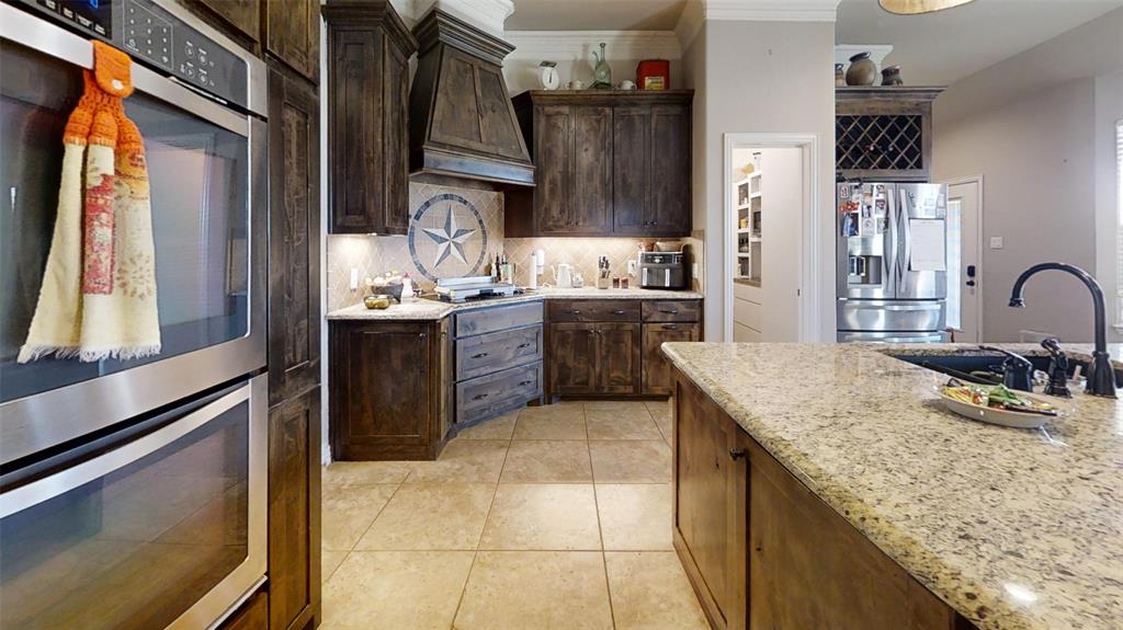 1431 Cheyenne Trail Nemo, TX 76070 - Photo 11 of 37 a kitchen with stainless steel appliances granite countertop a sink counter space and a window