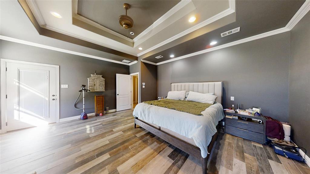 1431 Cheyenne Trail Nemo, TX 76070 - Photo 16 of 37 a bedroom with a bed and a chandelier