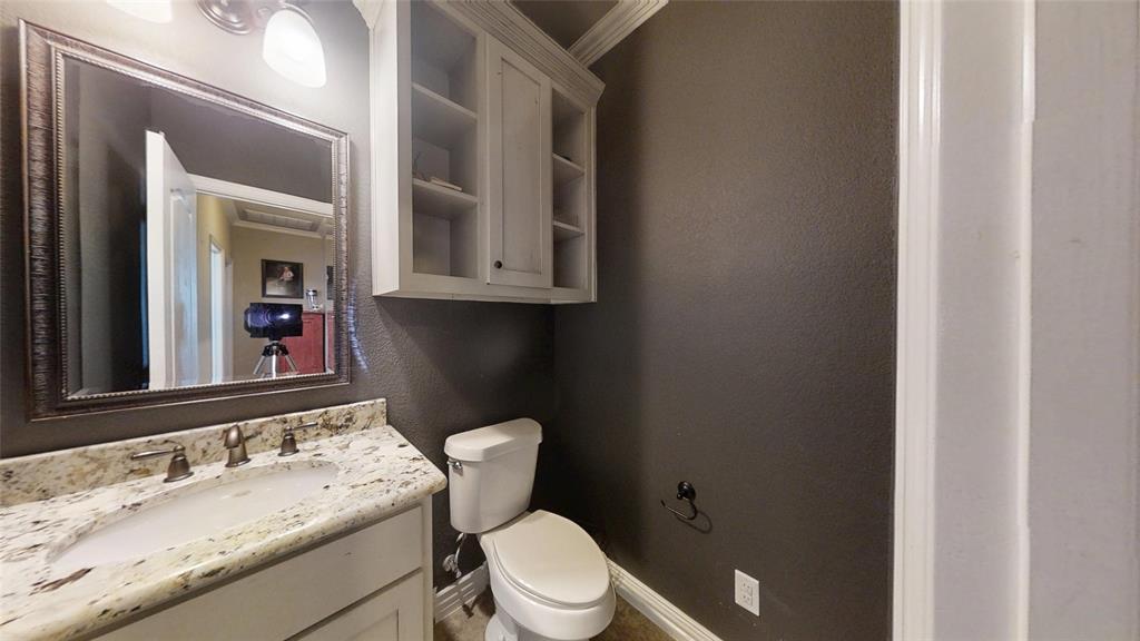 1431 Cheyenne Trail Nemo, TX 76070 - Photo 22 of 37 a bathroom with a granite countertop sink a mirror and a toilet