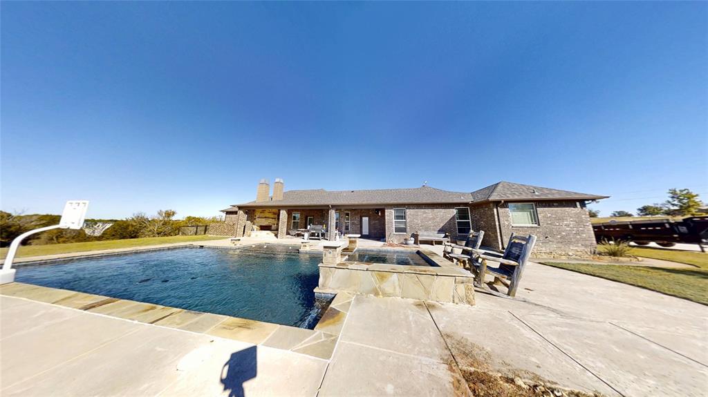 1431 Cheyenne Trail Nemo, TX 76070 - Photo 25 of 37 a view of a patio with dining table and chairs under an umbrella