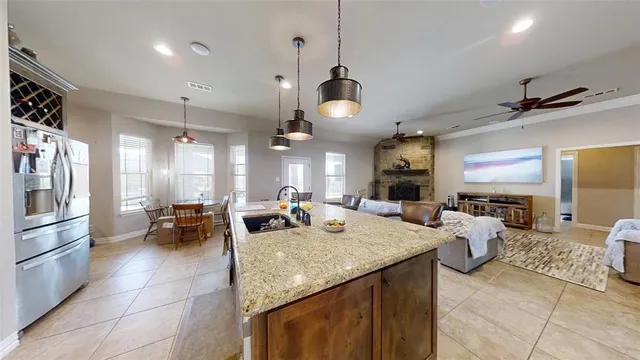 a view of a dining room and livingroom with furniture wooden floor a chandelier
