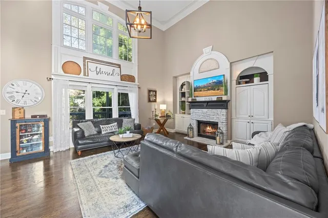 a living room with furniture a fireplace and wooden floor