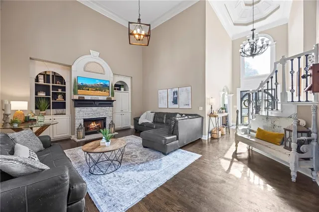 a living room with furniture fireplace and dining table