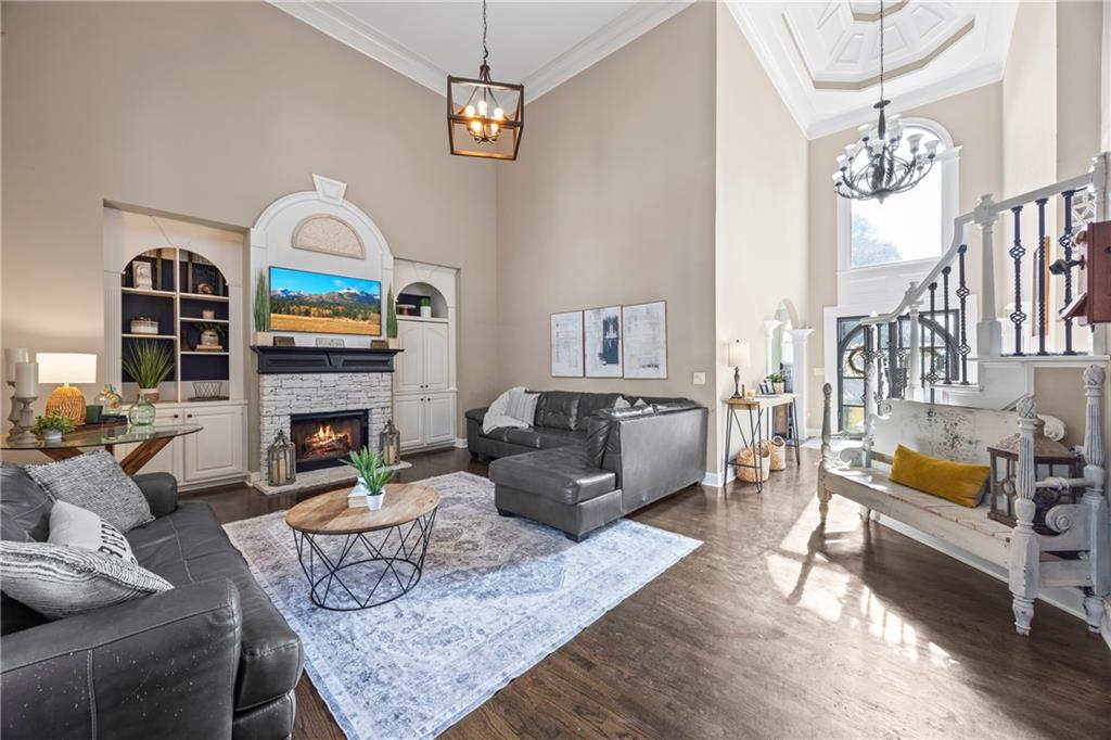 3420 Millwater Crossing Northeast Dacula, GA 30019 - Photo 12 of 54 a living room with furniture fireplace and dining table