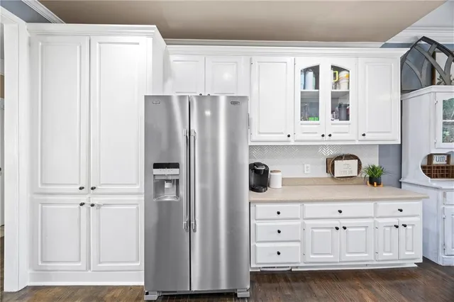 a kitchen with stainless steel appliances a refrigerator and cabinets