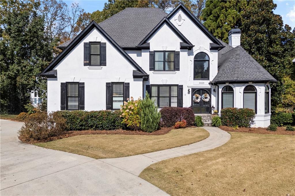3420 Millwater Crossing Northeast Dacula, GA 30019 - Photo 2 of 54 a front view of a house with a yard