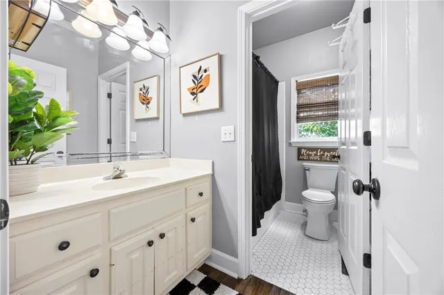 a spacious bedroom with a bed dresser and a window