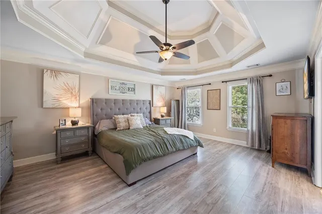 a bedroom with a large bed and a chandelier