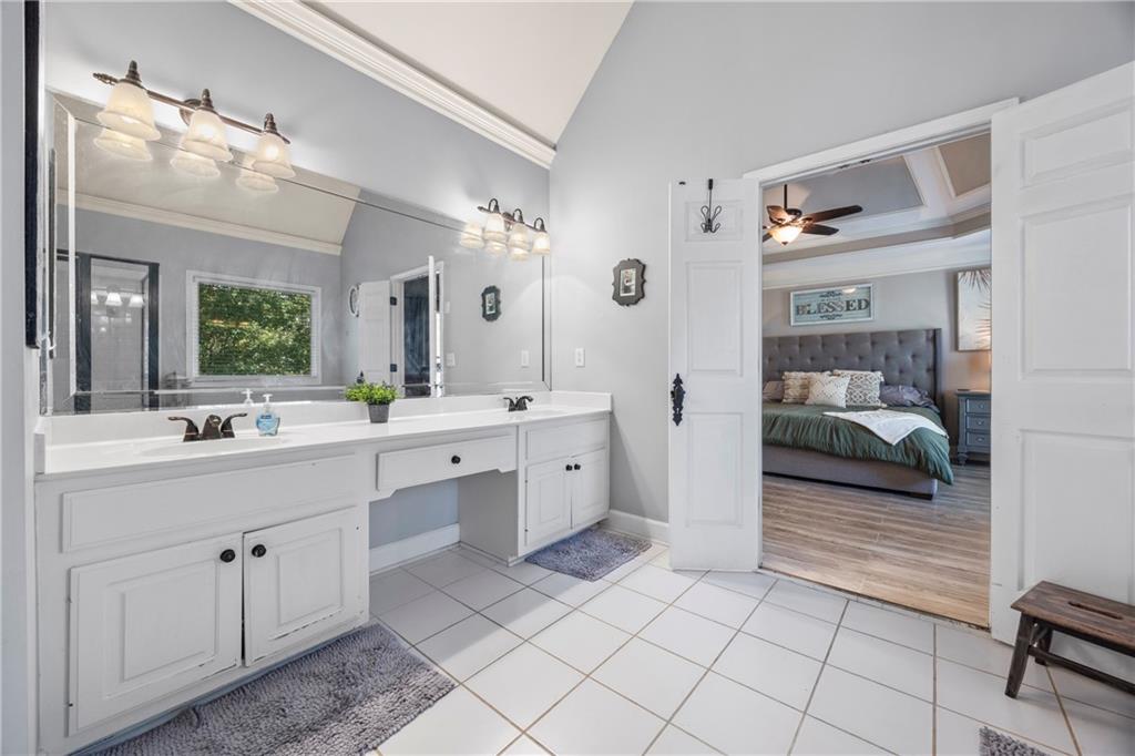 3420 Millwater Crossing Northeast Dacula, GA 30019 - Photo 26 of 54 a en suite bathroom with a toilet a sink and mirror