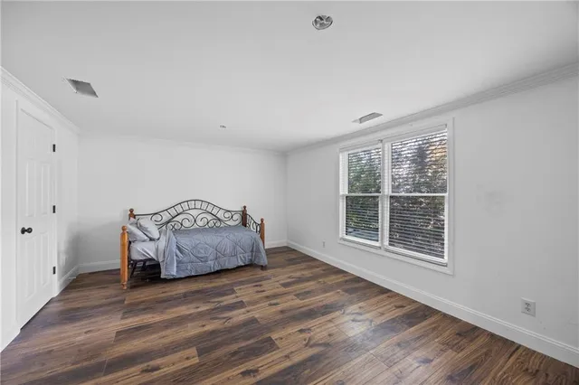 a spacious bathroom with a tub sink and mirror