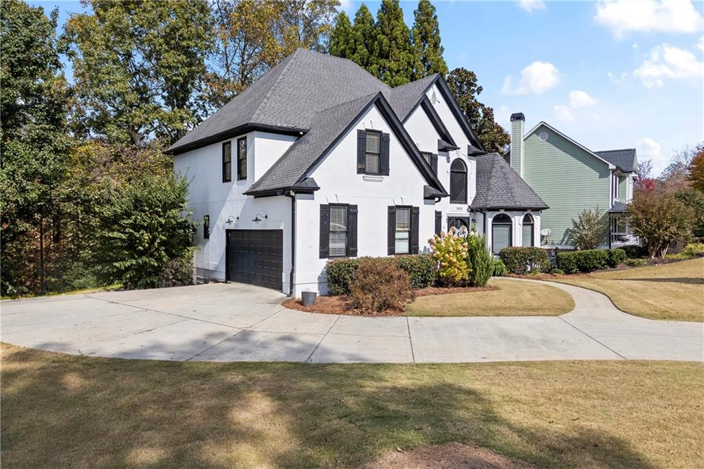 3420 Millwater Crossing Northeast Dacula, GA 30019 - Photo 4 of 54 a front view of a house with a yard