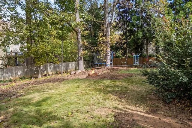 a view of a swimming pool with a yard and sitting area