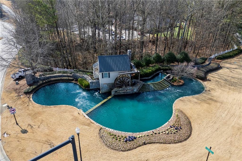 3420 Millwater Crossing Northeast Dacula, GA 30019 - Photo 46 of 54 a view of a swimming pool with a yard and sitting area