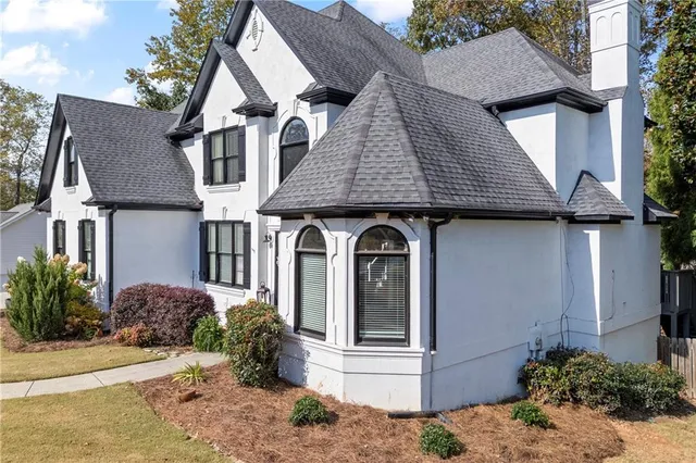 a front view of a house with garden