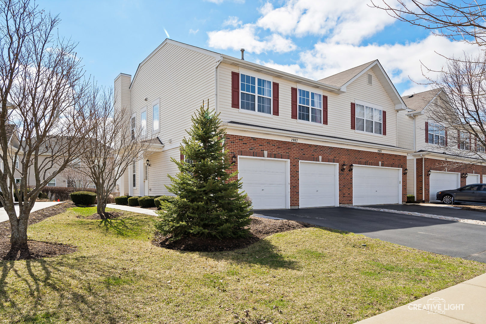 a front view of a house with a yard and garage
