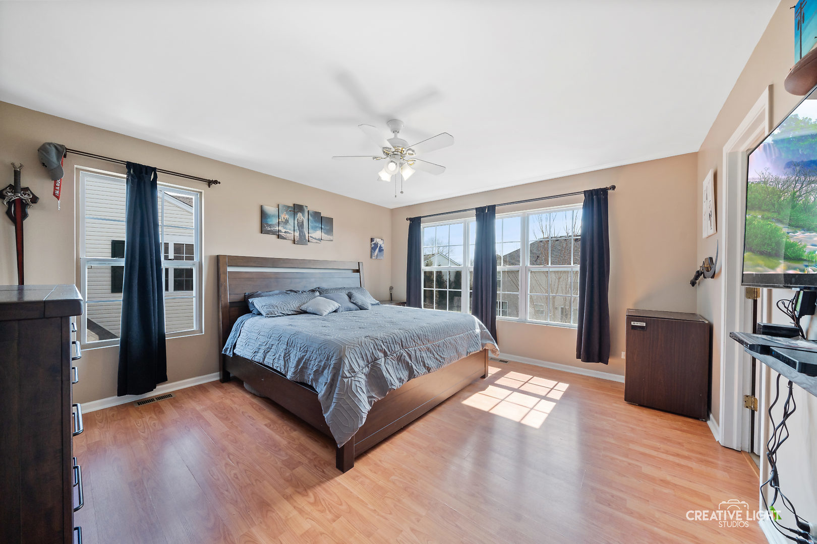 1987 West Cobblestone Road Romeoville, IL 60446 - Photo 12 of 20 a spacious bedroom with a large bed and a chandelier