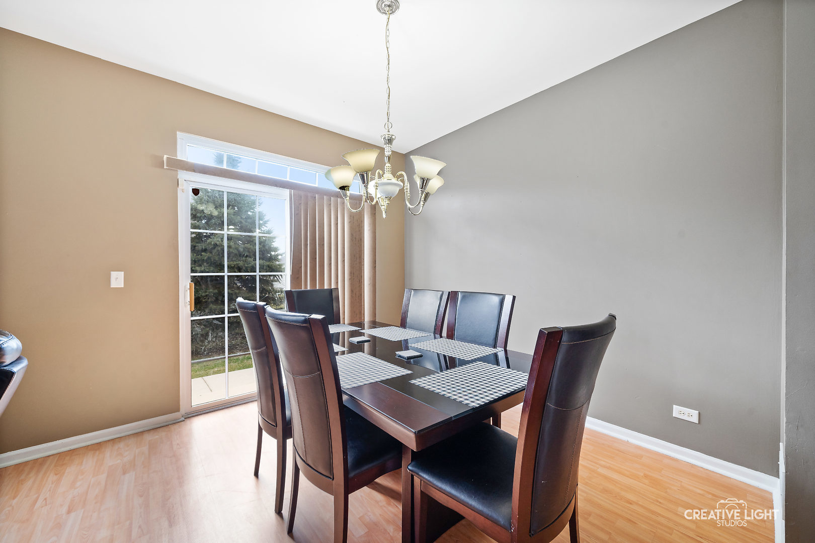 1987 West Cobblestone Road Romeoville, IL 60446 - Photo 6 of 20 a dining room with furniture a chandelier and wooden floor